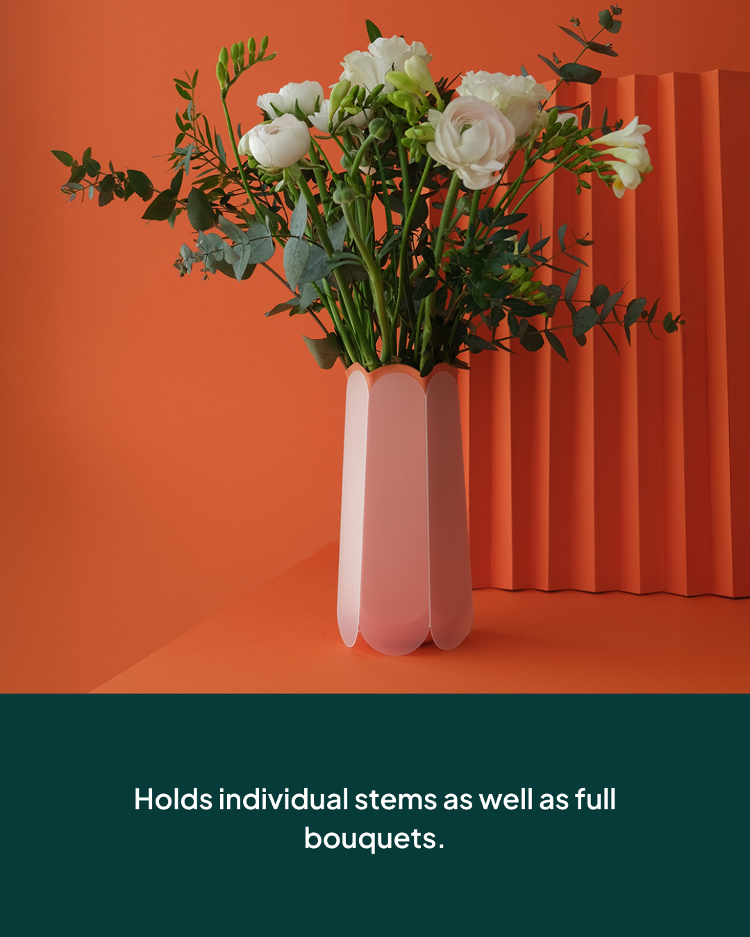 POTR Letterbox vase holding individual stems and full bouquets against a vibrant orange background.